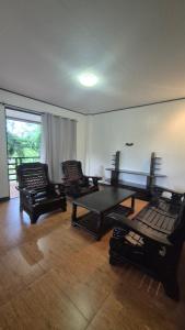 a living room with a ping pong table and chairs at Malaika Residence in Sampong +2 photos