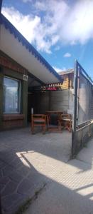 a building with a picnic table and a fence at Rayen hue in Esquel +2 photos