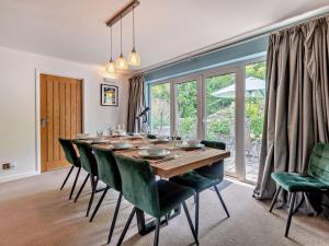 a dining room with a long table and green chairs at 5 Bed in Wareham oc-83036 in West Lulworth