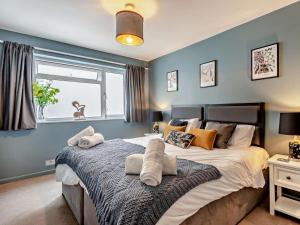 a bedroom with a large bed with pillows on it at 5 Bed in Wareham oc-83036 in West Lulworth