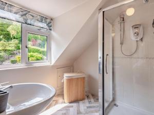 a white bathroom with a tub and a shower at 5 Bed in Wareham oc-83036 in West Lulworth