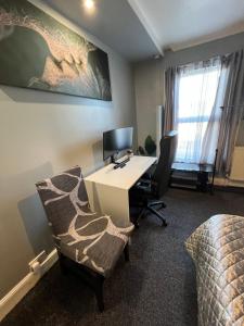 an office with a desk with a computer and a chair at accommodation near Luton city centre in Luton