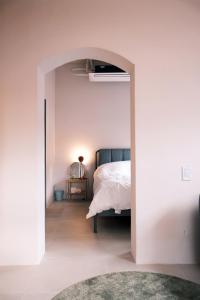 a bedroom with a bed and an open doorway at 협재10분 영주스테이 in Suwŏn-ni