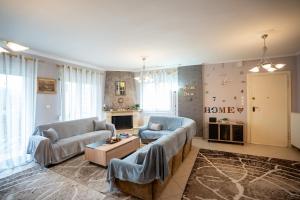 a living room with two couches and a table at DREAM Home Ioannina in Ioannina