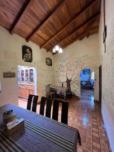 a dining room with a table and some chairs at Pakarina Hospedaje in Cotacachi