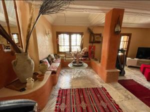 a living room with a couch and a table at Darsawani in Triffa