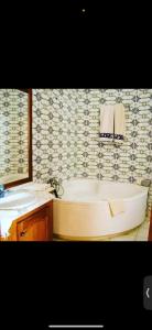 a bathroom with a bath tub and a sink at Darsawani in Triffa