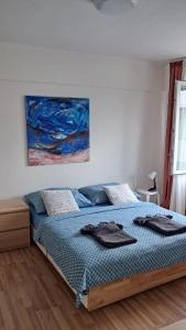 a bedroom with a bed with a blue comforter at Ubytování v centru Ostravy in Moravská Ostrava