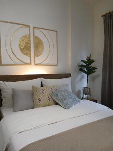 a bedroom with a white bed with two pillows at Luxury Spot Xanthi in Xanthi