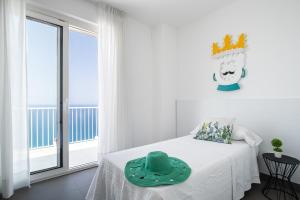 a bedroom with a bed with a crown on the wall at Villa Stellata in Naso +39 photos