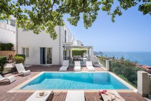 a swimming pool in the backyard of a house at Villa Stellata in Naso