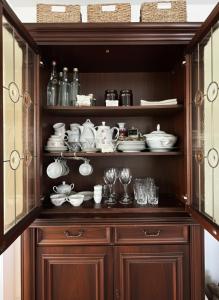 a hutch filled with lots of dishes and cups at Mystic Twistic in Vîrfurile +68 photos