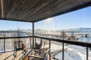a room with a view of the snow covered mountains at Njord in Tromsø