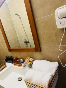 a bathroom with a sink and a mirror at Hà Nội Mái Hiên Home in Hanoi +36 photos