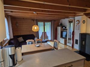 a living room with a couch and a table at Triberga Verwall in Sankt Gallenkirch +10 photos