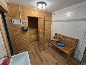 a bathroom with a bench next to a sink at Triberga Verwall in Sankt Gallenkirch