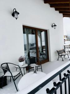 a patio with chairs and a table on a balcony at ORAWSKA CHATA - domek z balią pod Babią Górą in Zubrzyca Górna