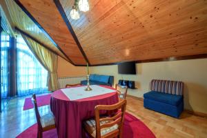 a living room with a table and a blue couch at Villa Requiem in Bednja