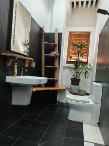 a bathroom with a white sink and a toilet at Surf'n Lanka - Surf School in Weligama +39 photos
