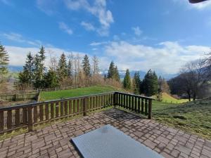 a patio with a bench on a wooden deck at Romantisches Bauernhaus in Sankt Veit im Pongau