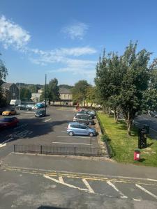 a parking lot with cars parked in a parking lot at Holgate Cottage in Great Harwood