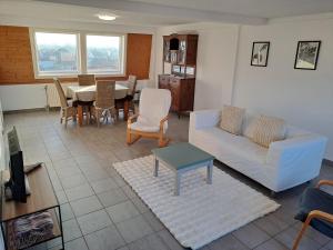 a living room with a couch and a table at De Peperbus in Lokeren