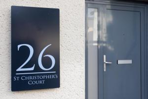 a sign on the side of a building with a door at Stunning Swansea Marina beach house with sea views in Swansea +26 photos