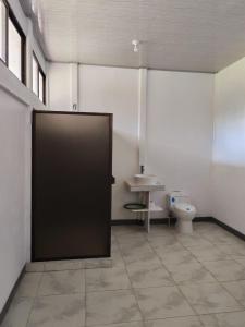 a bathroom with a toilet and a sink at Aura Living in La Garita