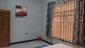 Dans place في موشي: غرفة نوم مع نافذة كبيرة مع ستائر