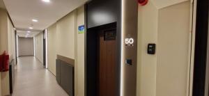 a hallway with a speed limit sign on the wall at Extra Apartman Palata in Banja Luka