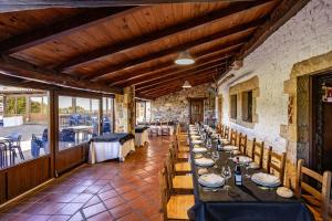 a dining room with a long table and chairs at Casona Asturiana Los Gamonales in Logrezana