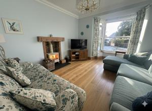 un soggiorno con divano e camino di Cartrefle - A Charming Welsh Escape perfect for families a St Clears