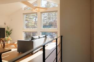 a living room with a couch and some windows at Peak Hakuba 峰白 in Nagano +106 photos