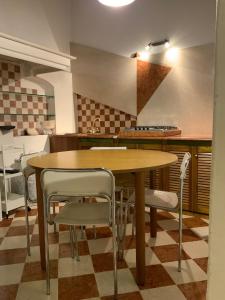 a kitchen with a wooden table and chairs at Ca' Molinetto in Treviso