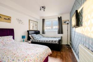 Ένα ή περισσότερα κρεβάτια σε δωμάτιο στο 3 beds,2 bedroom apt near city centre Glasgow