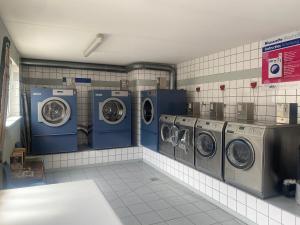a laundry room with four washing machines in a room at Ferien-Chalet Oostkapelle in Oostkapelle