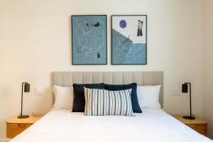 a bedroom with a bed with three pictures on the wall at Modern Stay in Plaza Castilla in Madrid