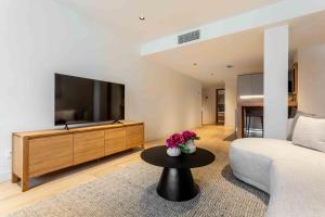 a living room with a couch and a tv and a table at Modern Stay in Plaza Castilla in Madrid