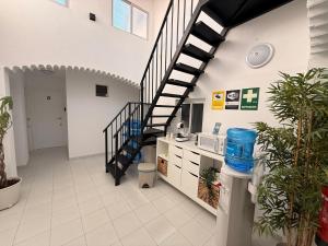 a hallway with a spiral staircase in a building at Hostal Merino Jédula in Jedula