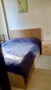 un letto con un piumone blu in una camera da letto di Уютная и светлая квартира с видом на горы a Tbilisi City