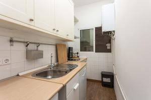 a kitchen with a sink and a refrigerator at Urban Nest Retreat in Madrid +13 photos