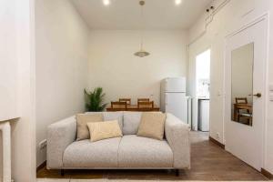 a living room with a couch and a table at Urban Nest Retreat in Madrid