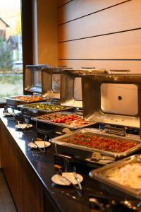 ein Buffet mit vielen verschiedenen Pizzen in der Unterkunft Ведмежа гора Panorama Spa Resort in Jaremtsche + 29 Fotos