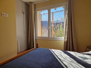 a bedroom with a bed and a window at Les Rives d 'Espalion in Espalion