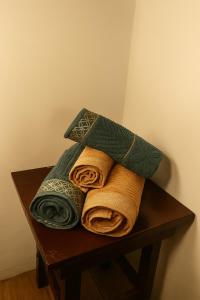 a pile of towels sitting on top of a table at Pousada do Pescador in Florianópolis