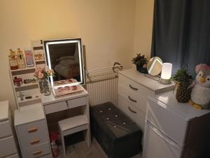 a bedroom with a dresser and a mirror at Howcroft 