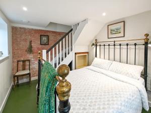 a bedroom with a large bed and a staircase at 3 Bed in Edenbridge oc-o34127 in Hever