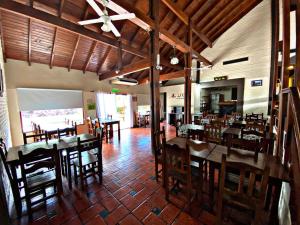 a dining room with tables and chairs in a restaurant at Altos del Rincón in Merlo