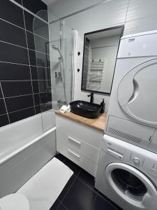 a bathroom with a sink and a washing machine at Apartman Lory, Zagreb, Downtown, with own parking in the garage in Zagreb