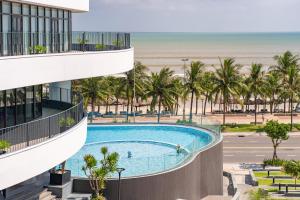 an overhead view of a swimming pool in front of the beach at Nesta Celia Danang Hotel in Danang